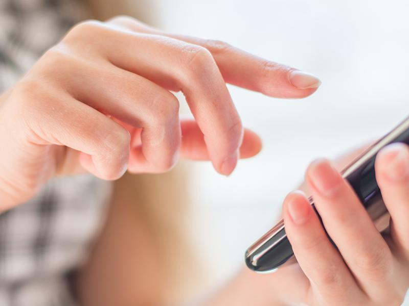 Hand using mobile phone