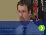 A doctor is shown giving a speach as part of the Health Watch: Winter Sports conference.