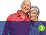 A smiling older couple is shown after managing their diabetes care.